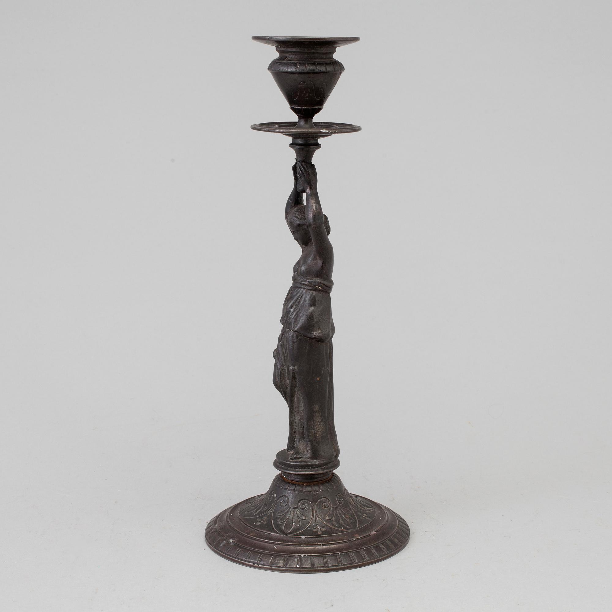 A 19th century iron candlestick marked F.L Vombach Offenbach A/M.
