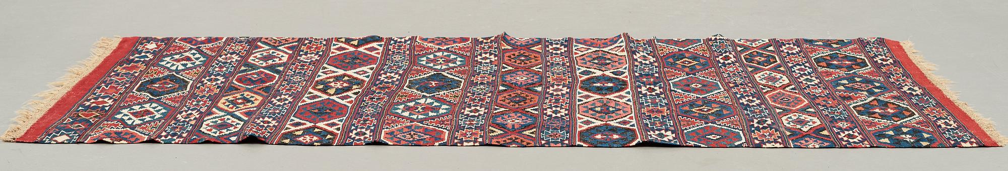 A CARPET, AN ANTIQUE AZERI KILIM, probably a Shirvan, ca 250 x 117,5 cm.