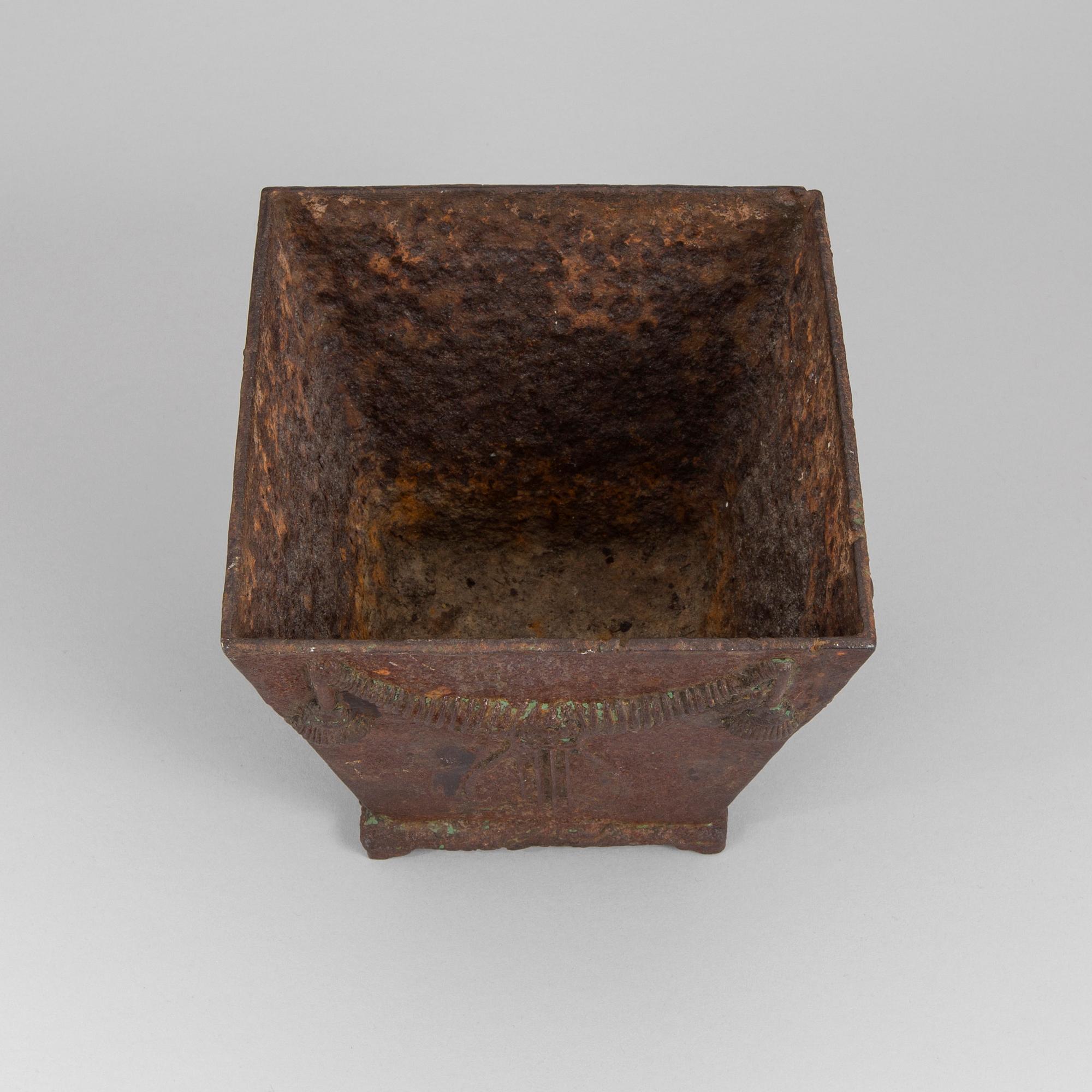 An early 19th century flower pot of cast iron.