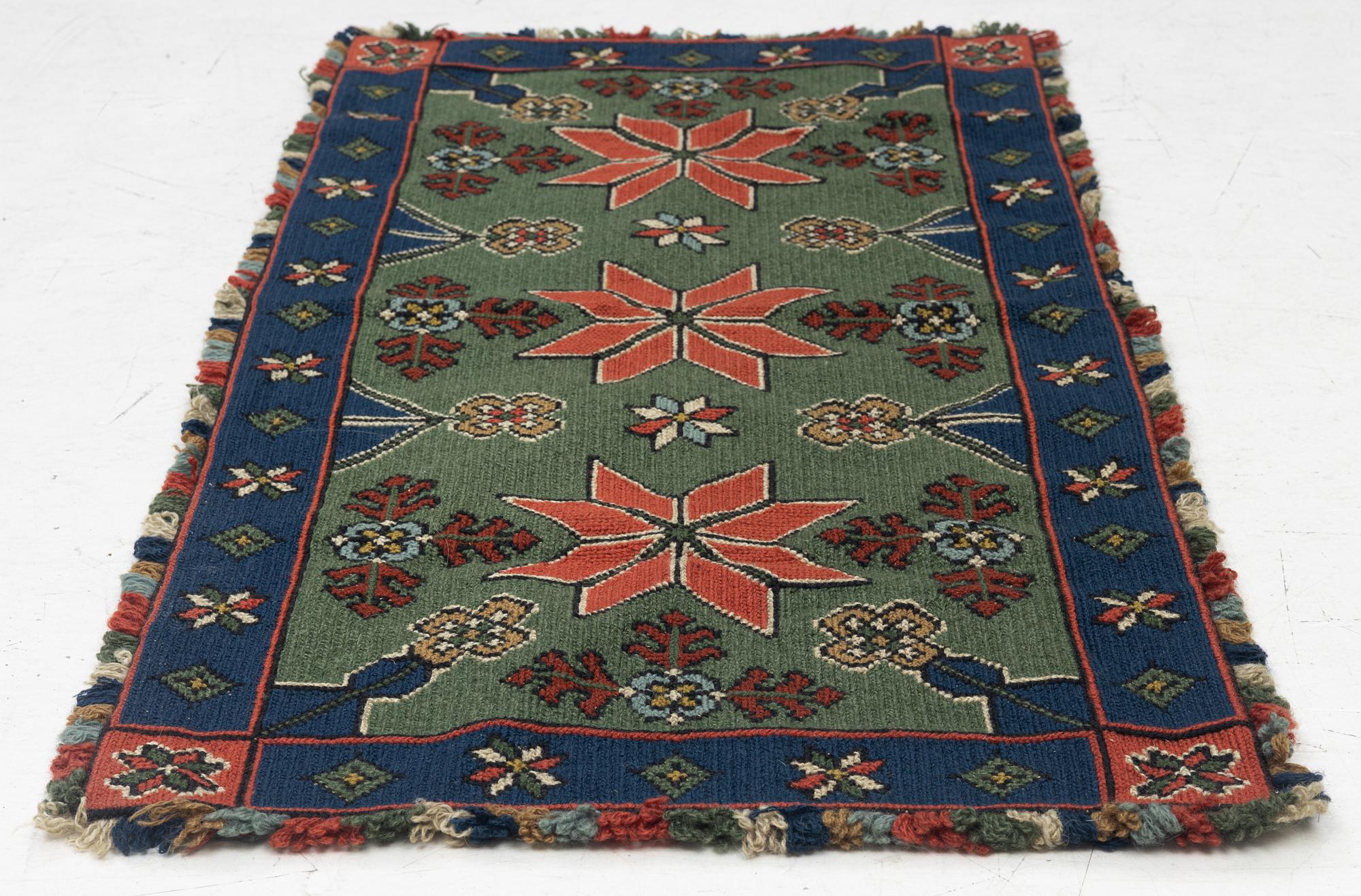 A Scania cross-stitch embroidered cushion, Sweden, around 1900, c. 99 x 47 cm.