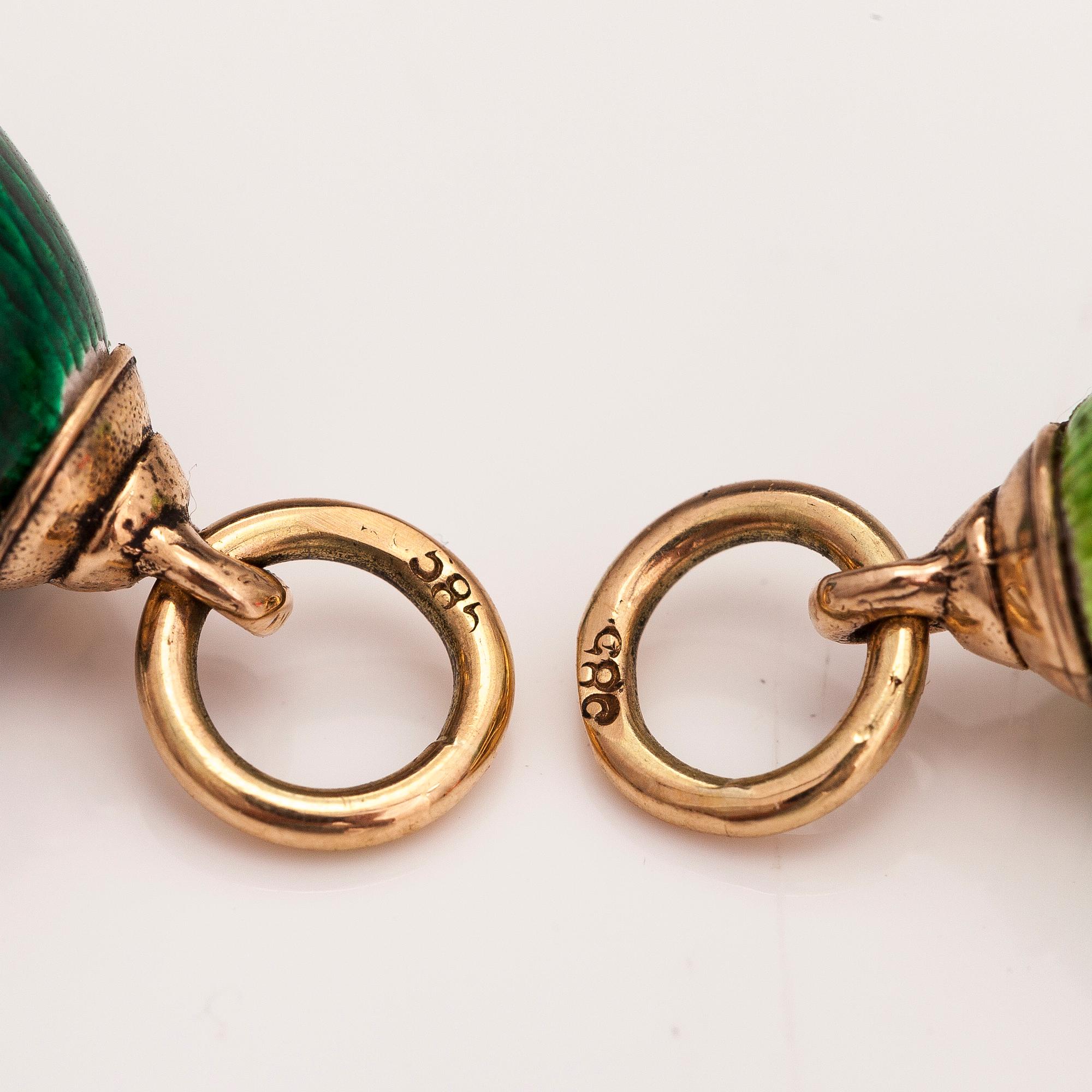 Two 14K gold pendants with enamel.