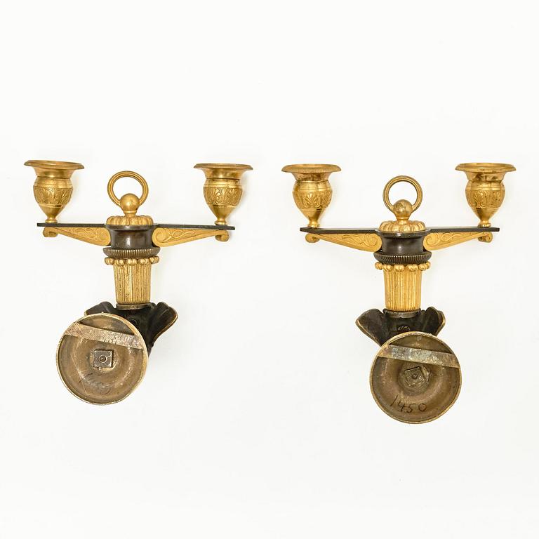 A pair of Empire patinated and ormolu two-branch appliques attr. to C. Galle (bronzier in Paris 1786-1815).