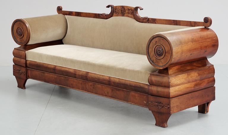 A mahogny veneer Empire sofa. 19th Century.
