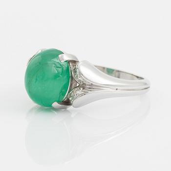 An 18K white gold ring set with a cabochon-cut emerald and eight-cut diamonds.