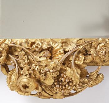 A presumably Dutch Louis XIV carved giltwood frame with mirror glass, in the style of Jean Le Pautre, late 17th century.