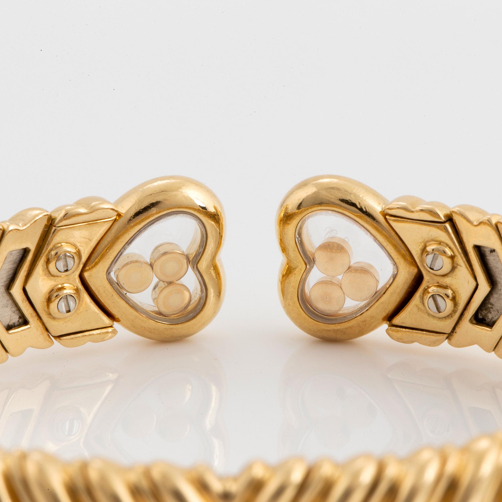 A Chopard "Happy Diamond" bangle in 18K gold.