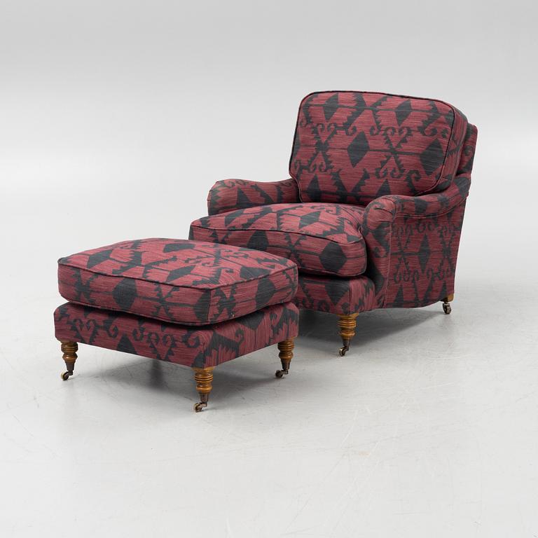 A Howard style easy chair with av footstool, 21st Century.