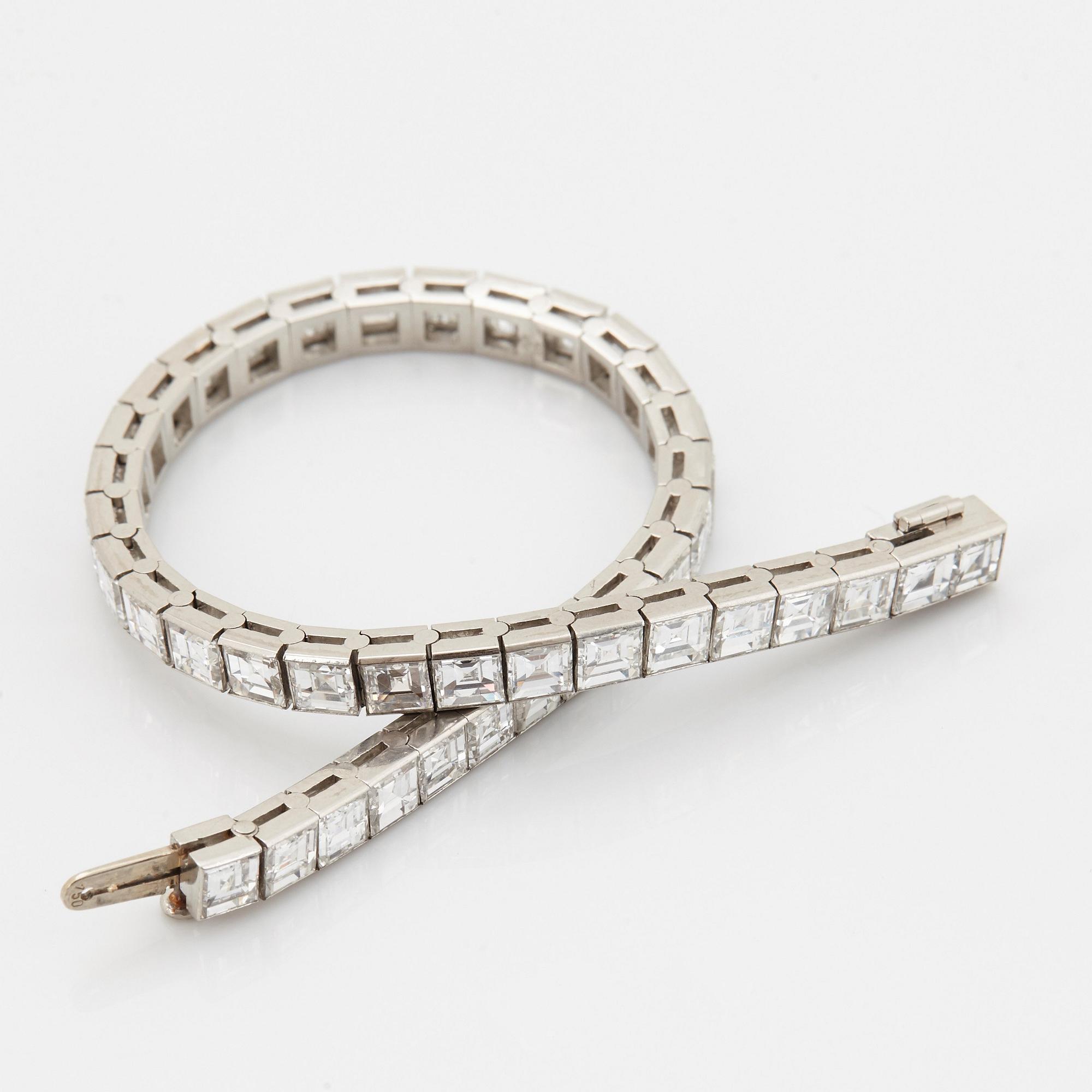 A platinum bracelet set with carré cut diamonds.