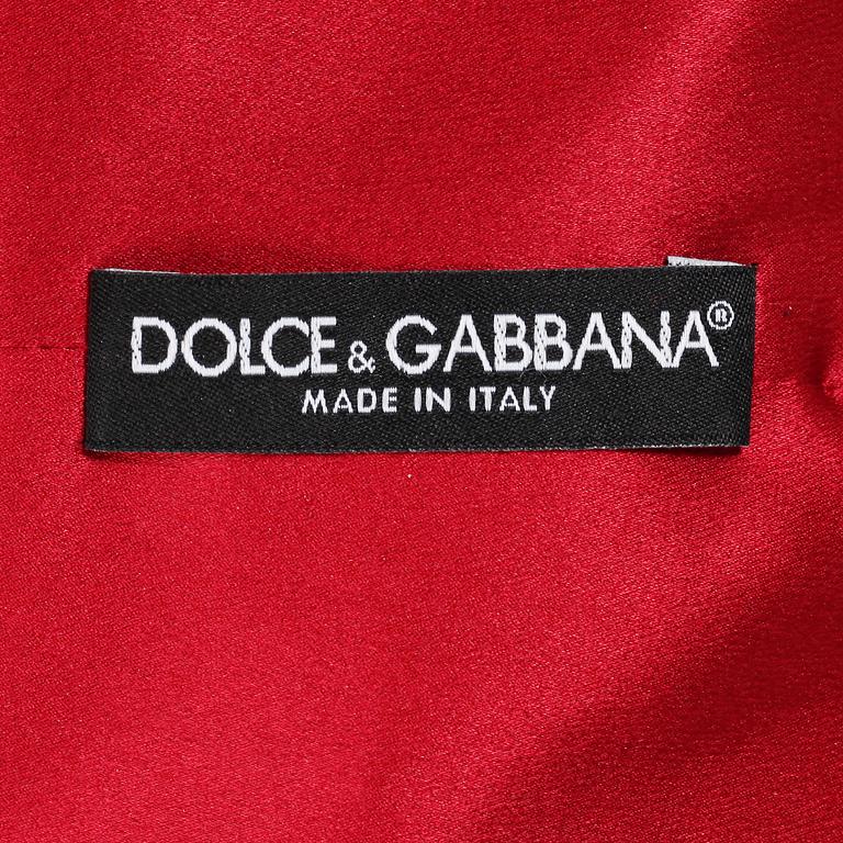 A red silk cocktail dress by Dolce & Gabbana.