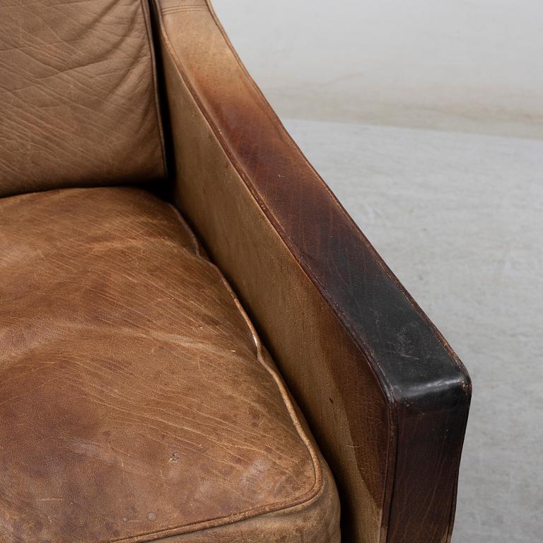 A 1960s easy chair and foot stool.