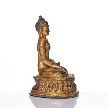 A gilt copper alloy figure of Buddha, Tibet/Nepal 15th Century.