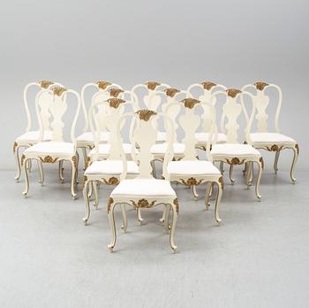 A dining table width twelve chairs, first half of the 20th century.