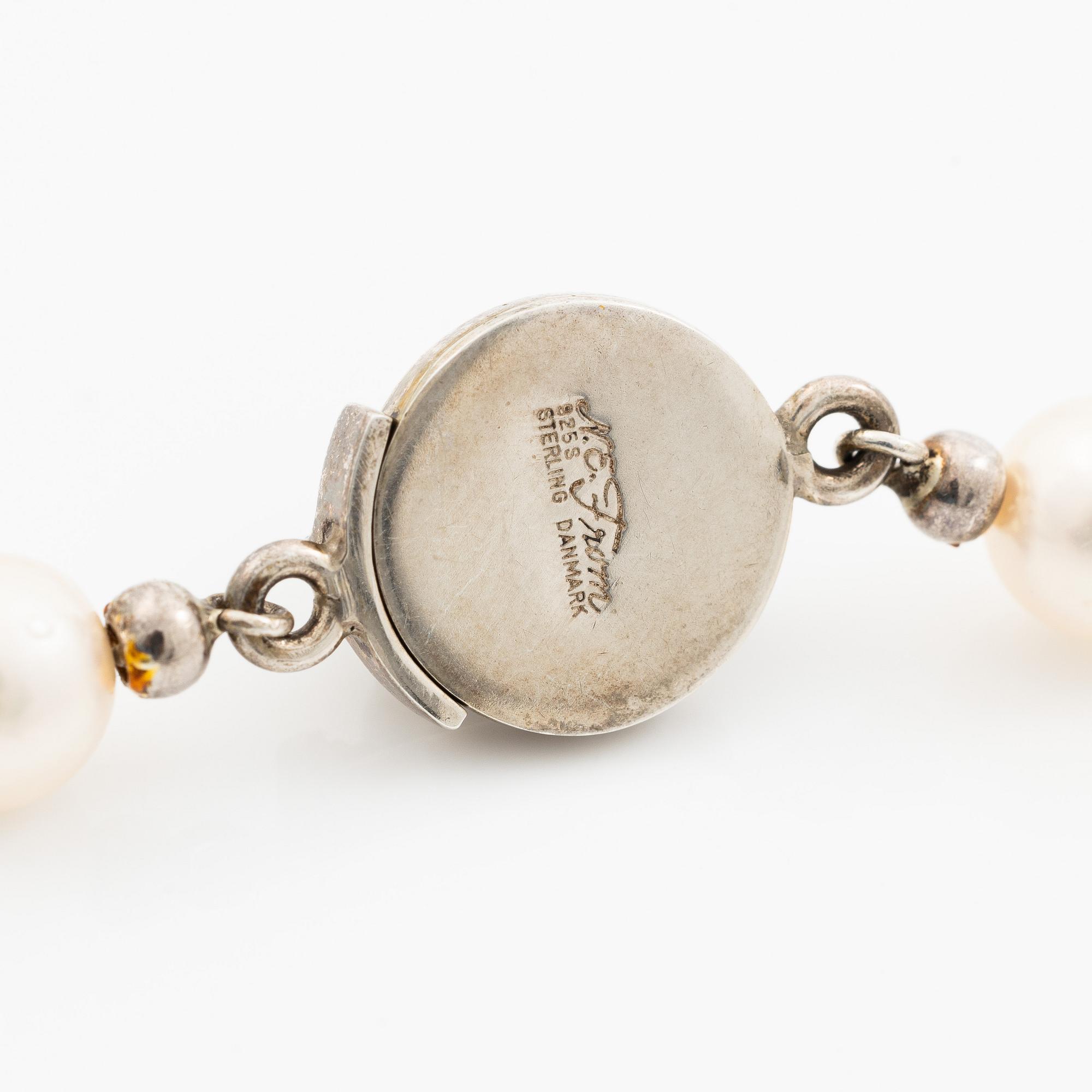 Cultured pearl necklace with Niels Erik From clasp, Denmark, silver set with a green cabochon-cut stone.