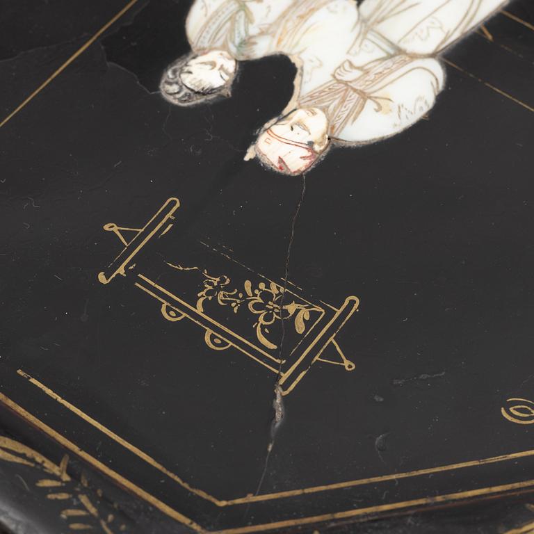 Four black-lacquered wall decorations, China, around 1900.