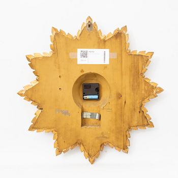 A mid 1900s gilded wall clock.