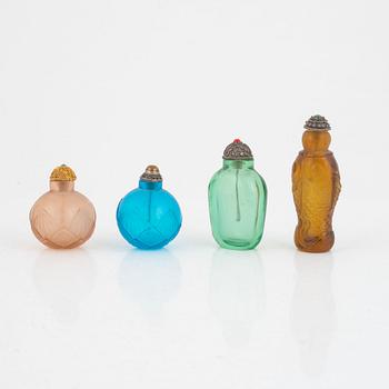 A group of four glass snuff bottles with stoppers, China, 20th century.