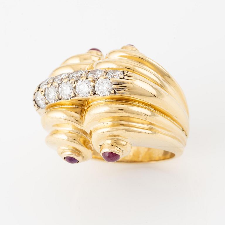 An 18K gold ring set with round brilliant-cut diamonds and cabochon-cut rubies.