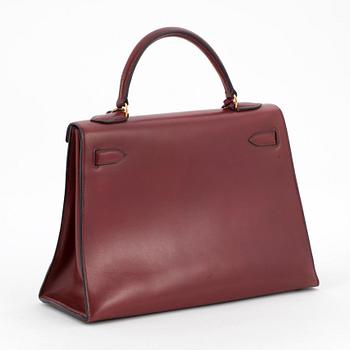 HERMÈS, a burgundy red handbag, "Kelly 32".