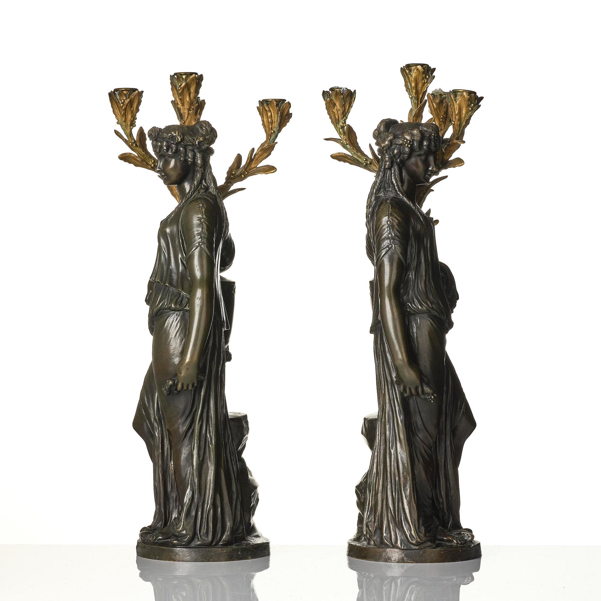 A pair of Louis XVI-style four-light gilt and patinated bronze candelabra after Clodion, later part 18th century.