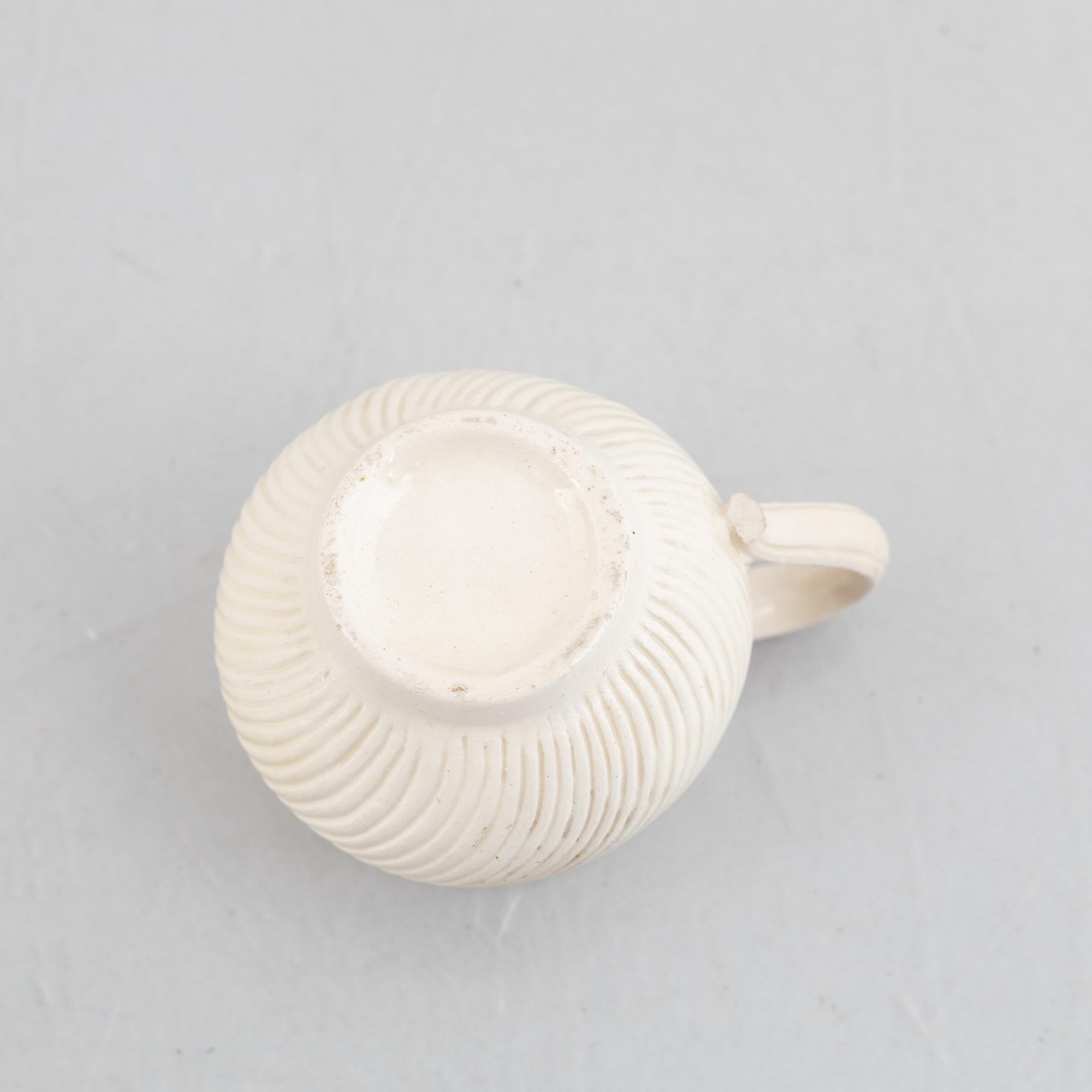 A set of six soft-paste porcelain custard cups with covers, 18th century.