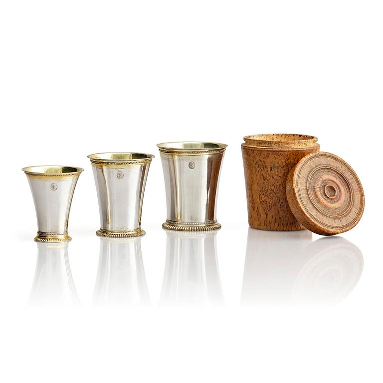 Three Swedish 18th century parcel-gilt silver beakers and a case of birch, different maker's.
