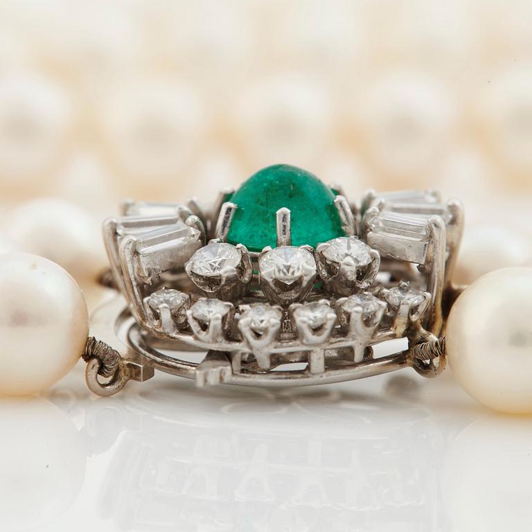 A three strand cultured pearl necklace, clasp with cabochon cut emerald circa 1.68 cts and diamonds.