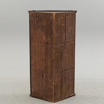 A 19th century corner cabinet.