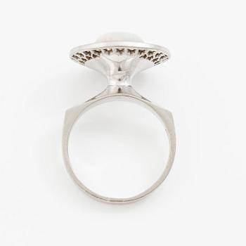 A ring 18K white gold set with an opal and eight-cut diamonds. CF Carlman, Stockholm 1973.