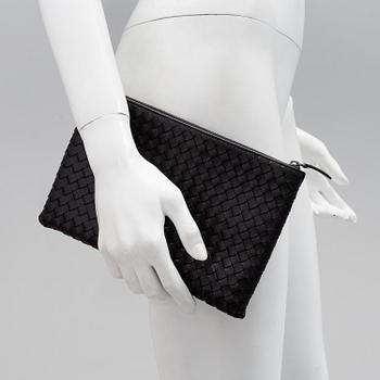 A black leather clutch by Bottega veneta.