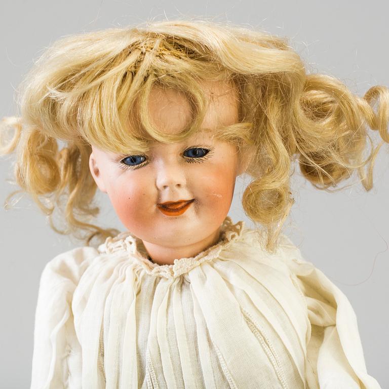 A mechanical bisque head doll by Heubach, probably 7669, Germany, c. 1912.