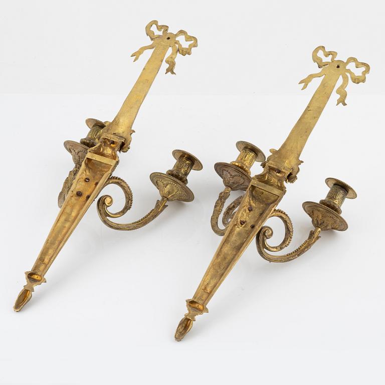 A pair of gilt brass wall sconces, Louis XVI-style, early 20th century.