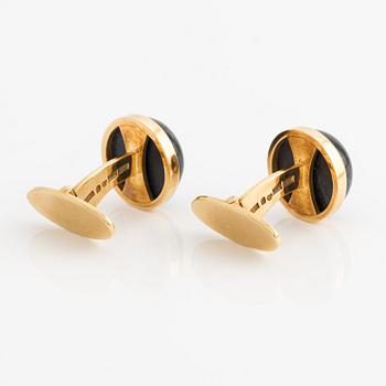 CF Carlman a pair of 18K gold cufflinks with a blue stone, likely spectrolite.