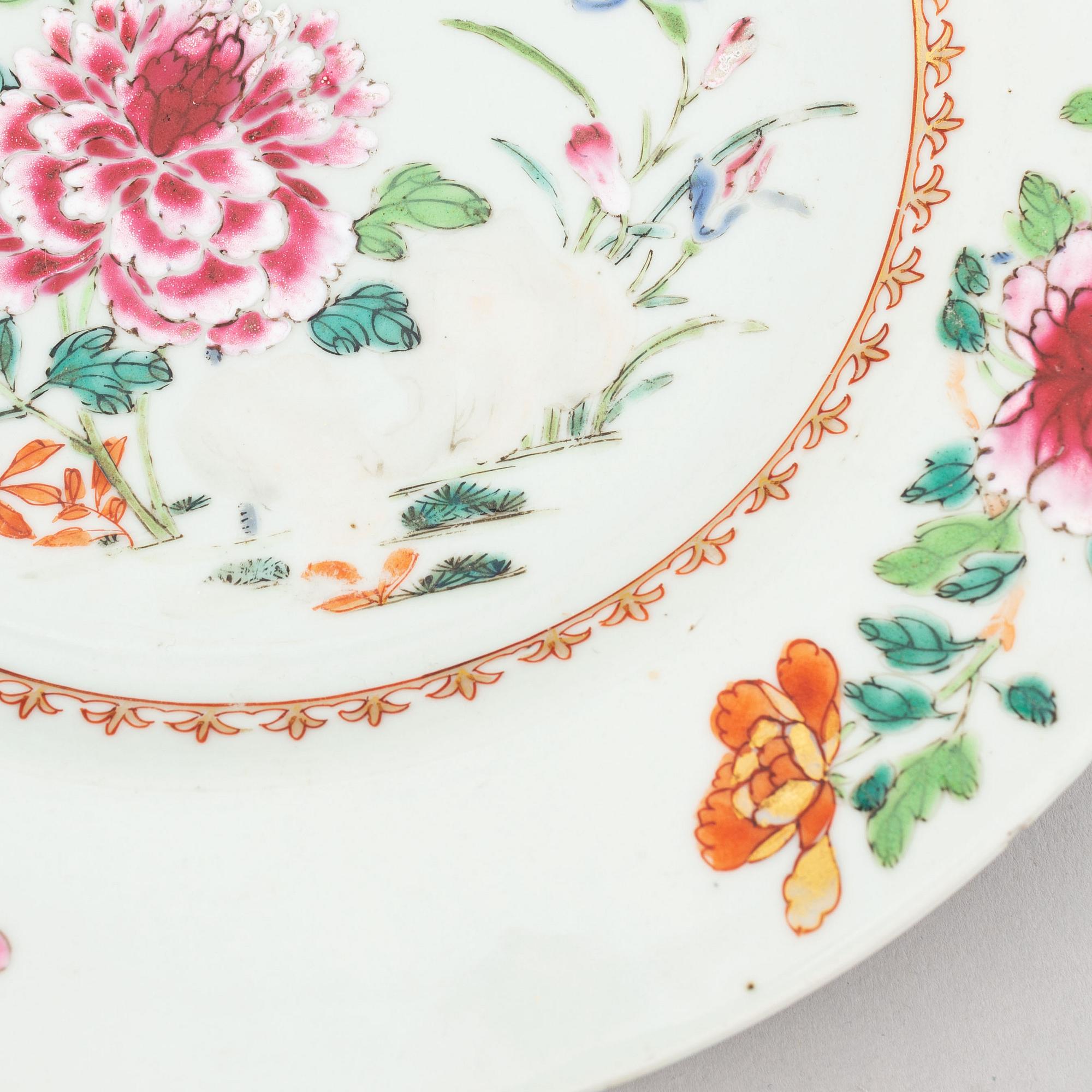 A set of two blue and white serving dishes, and two famille rose dinner plates, Qing dynasty, Qianlong (1736-95).