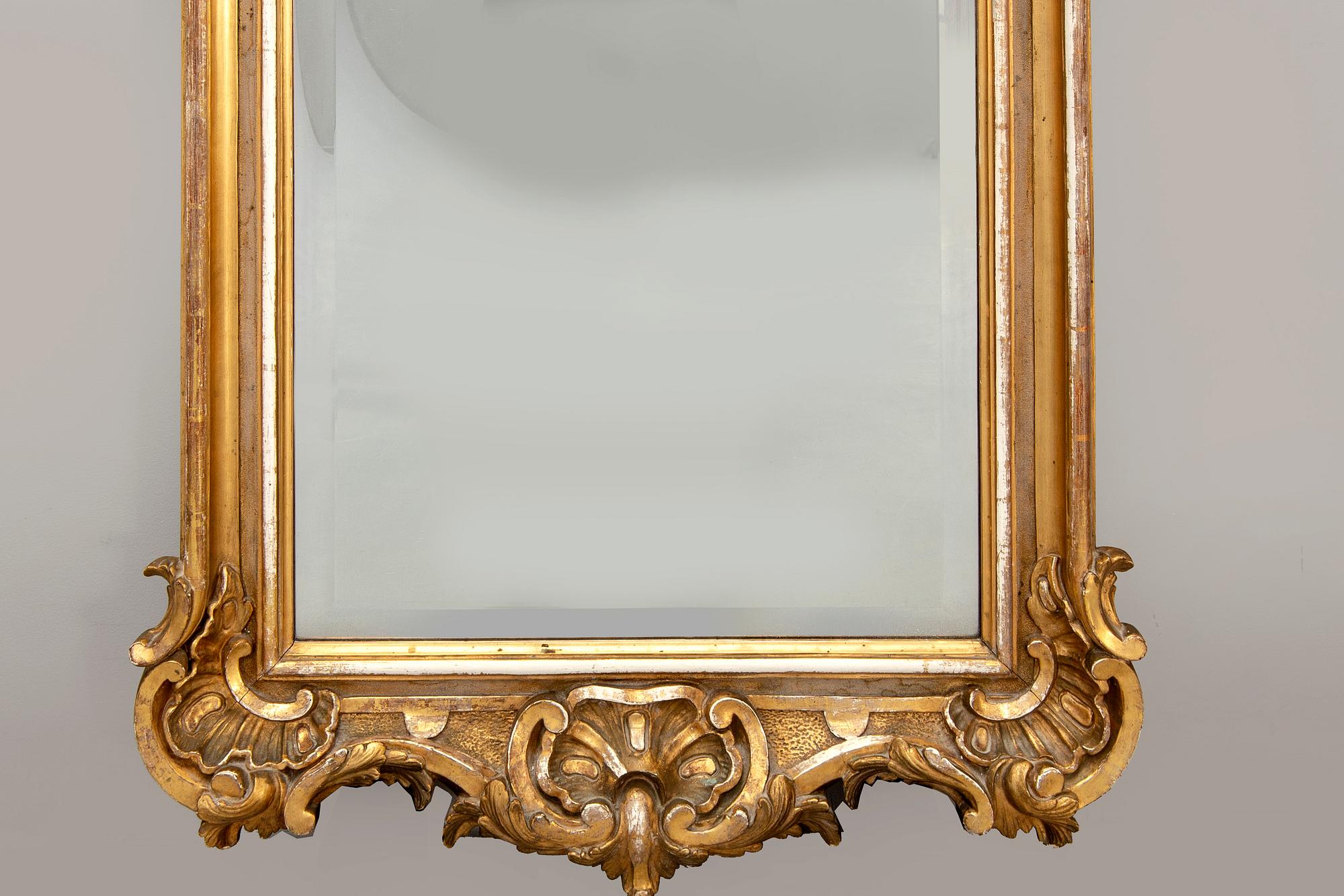 A Swedish Neo Rococo gilded signed mirror 1880s.