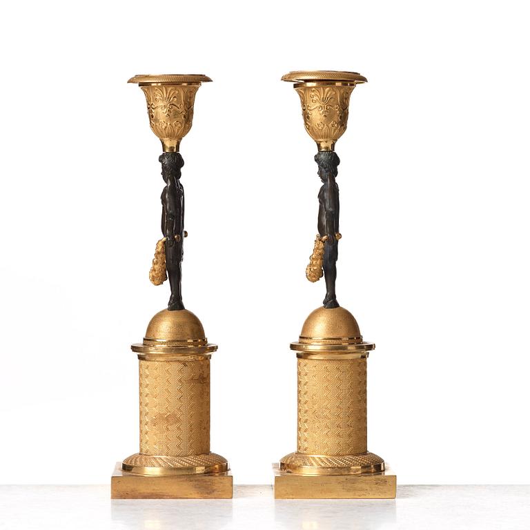 A pair of Empire early 19th century candlesticks.