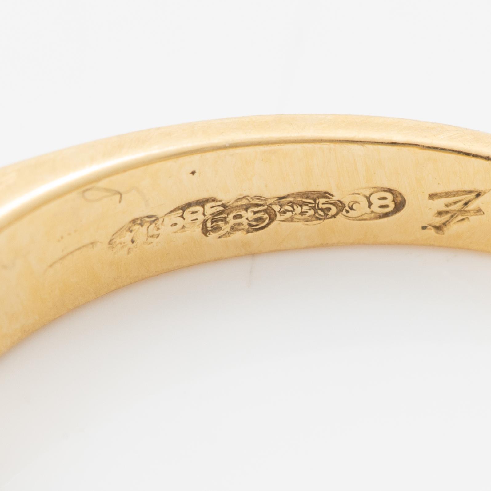 14K gold ring with princess-cut diamonds.