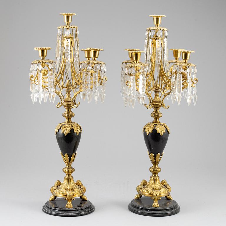 A pair of Oscarian candelabra in stone and brass.