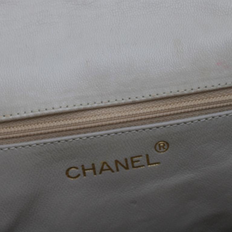 CHANEL, a beige shoulder bag.