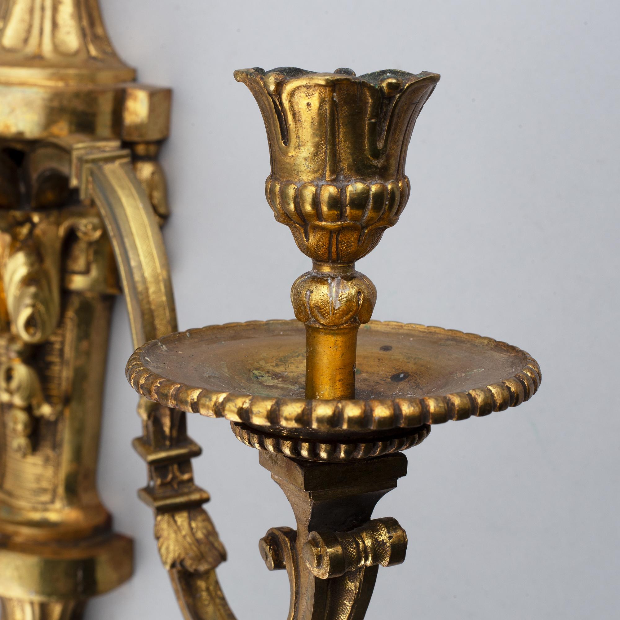 A pair of gilt bronze Louis XVI style wall lights. Late 19th century. 80.