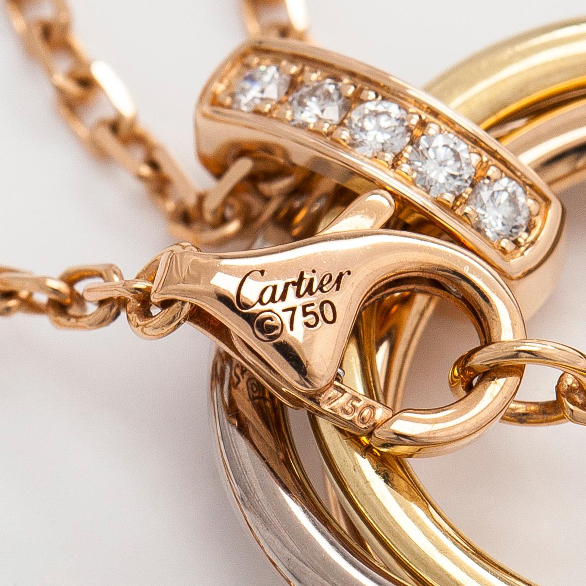 Cartier, an 18K gold 'Trinity Pendant' necklace with brilliant-cut diamonds.