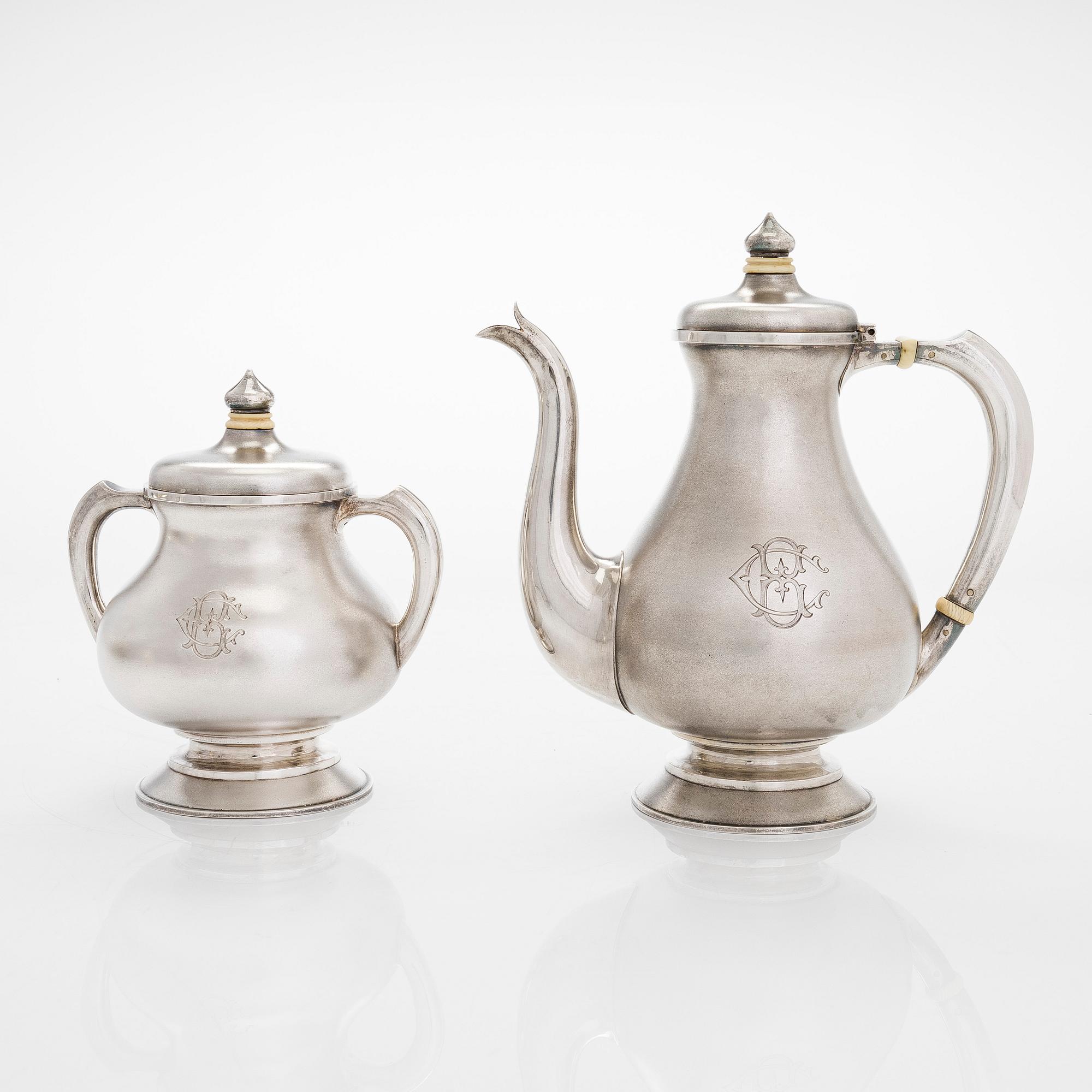 A four-piece silver coffee set, St. Petersburg 1887, original fitted box from Khlebnikov. Sugar tong, Moscow around 190.
