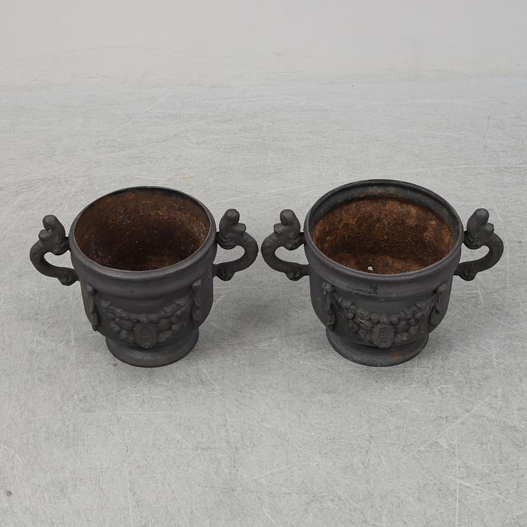 Two 20th Century cast iron flower pots.