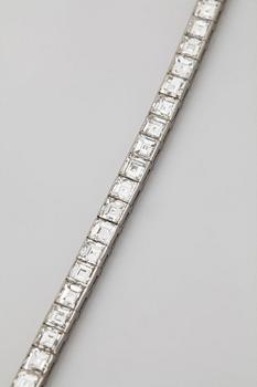 A platinum bracelet set with carré cut diamonds.