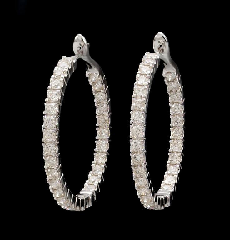 A pair of gold and diamond earrings.