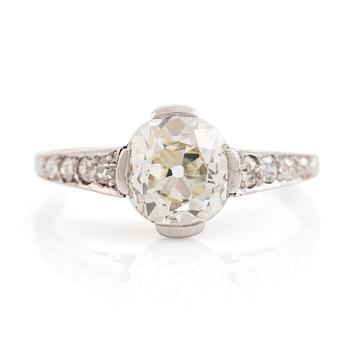A platinum ring set with a cushion-formed old-cut diamond.