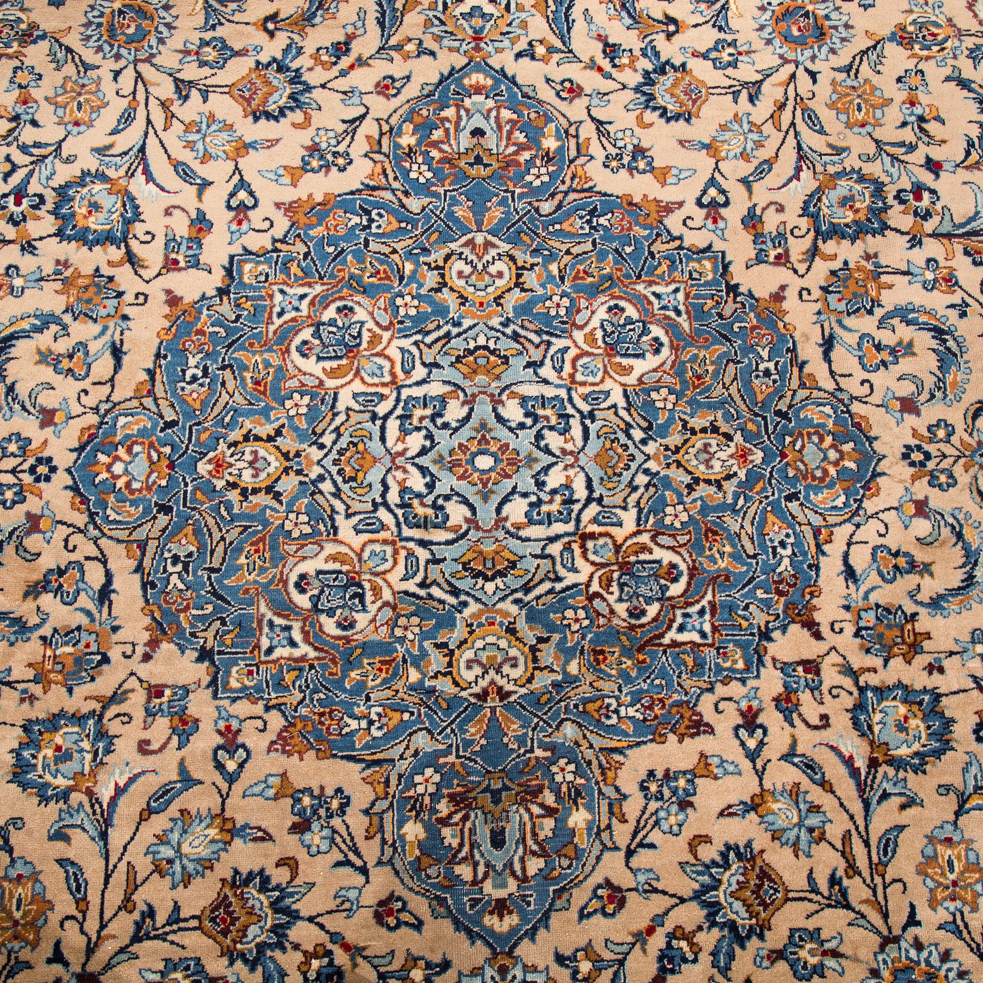 A carpet from Mashad, around 381 x 297 cm.