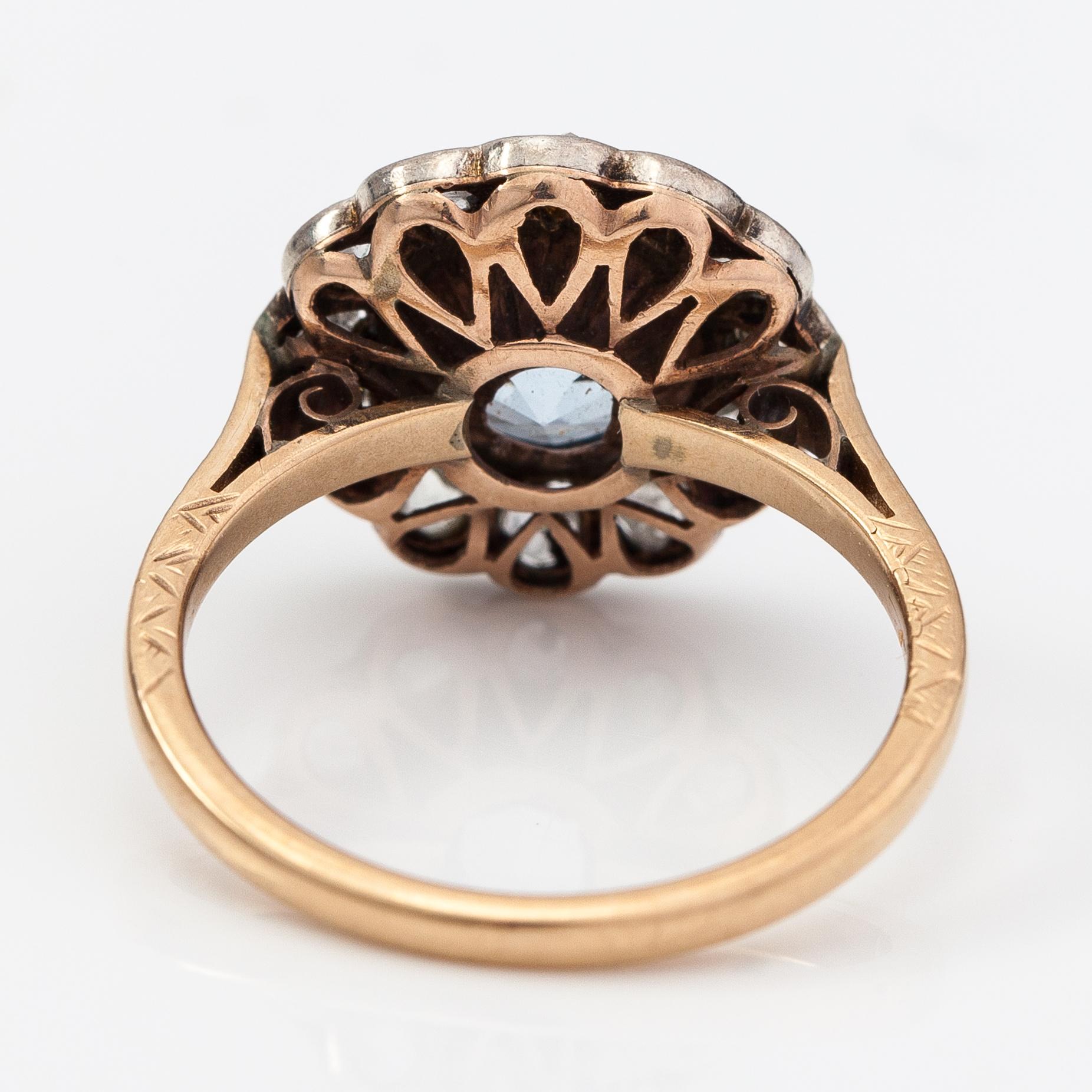 A 13-14K gold ring with a synthetic spinelle and rose-cut dimaonds.
