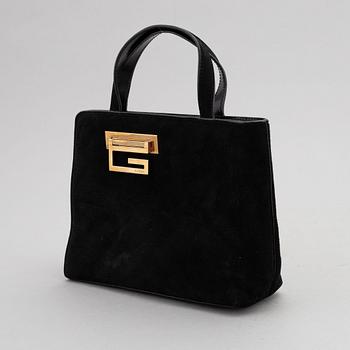 Gucci, a black suede handbag.
