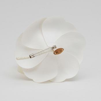 CHANEL, a white brooch.