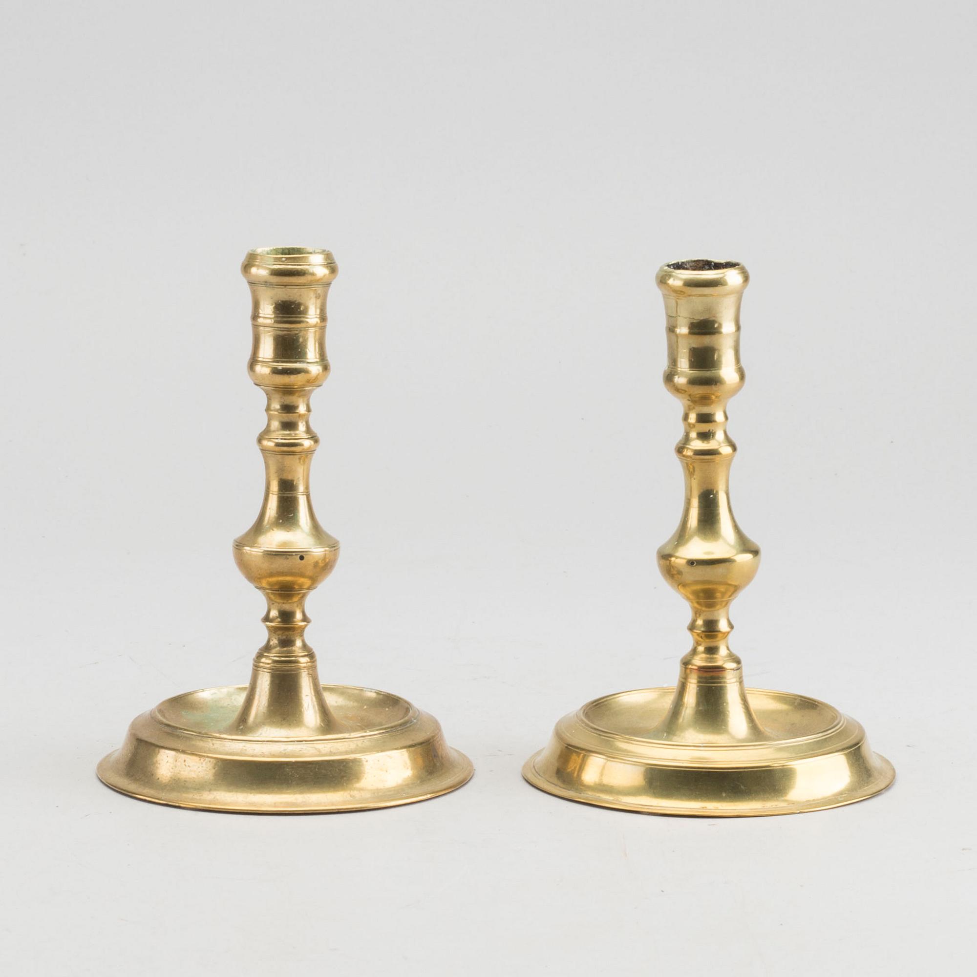 A set of two of brass candle sticks mid 18th century.